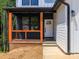 Charming front porch with black railings, natural wood posts, and the house number displayed prominently at 135 Brookview Dr, Shelby, NC 28152
