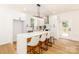 Kitchen featuring an island with barstool seating, stainless steel appliances, white cabinetry, and hardwood floors at 135 Brookview Dr, Shelby, NC 28152