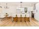 Open-concept kitchen and dining area with hardwood floors, white cabinets, stainless appliances, and a large island at 135 Brookview Dr, Shelby, NC 28152