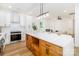 Open kitchen featuring an island with barstool seating and stainless appliances flowing into living space at 135 Brookview Dr, Shelby, NC 28152