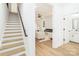 Open staircase leading to a bright living area, seamlessly connected to a half bath at 135 Brookview Dr, Shelby, NC 28152