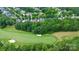 An aerial view of a golf course home with a lush green fairway in the background at 13824 Glen Abbey Dr, Charlotte, NC 28278
