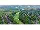 An aerial view of a property with lake views nestled alongside a scenic golf course at 13824 Glen Abbey Dr, Charlotte, NC 28278