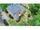 A stunning aerial view of a brick home with a lush backyard and patio at 13824 Glen Abbey Dr, Charlotte, NC 28278