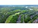 An aerial view of a community near a golf course and lake at 13824 Glen Abbey Dr, Charlotte, NC 28278