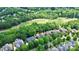 A stunning aerial view of a home near a golf course surrounded by mature trees at 13824 Glen Abbey Dr, Charlotte, NC 28278