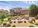 Spacious backyard with multiple seating areas, fire pit and mature trees at 13824 Glen Abbey Dr, Charlotte, NC 28278