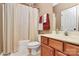 Well-lit bathroom with a shower, vanity, sink, and a coordinated towel set at 13824 Glen Abbey Dr, Charlotte, NC 28278
