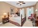 Cozy bedroom features a decorative bed frame, ceiling fan, and plush textiles for a relaxing retreat at 13824 Glen Abbey Dr, Charlotte, NC 28278