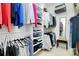 This walk-in closet has ample storage space, with shelving, hanging racks, and room for shoes and accessories at 13824 Glen Abbey Dr, Charlotte, NC 28278