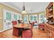 Dining area with hardwood floors, ample natural light, and access to the outdoor space through glass doors at 13824 Glen Abbey Dr, Charlotte, NC 28278