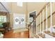 Bright foyer with hardwood floors, a staircase, and double doors with decorative wreaths at 13824 Glen Abbey Dr, Charlotte, NC 28278