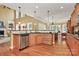 Open kitchen with modern appliances, wooden cabinets, and hardwood floors at 13824 Glen Abbey Dr, Charlotte, NC 28278