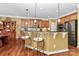Kitchen with hardwood floors, stainless steel appliances, granite countertops, and a bar area with seating at 13824 Glen Abbey Dr, Charlotte, NC 28278