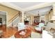 Open-concept living room featuring hardwood floors, neutral colors, and elegant furnishings at 13824 Glen Abbey Dr, Charlotte, NC 28278