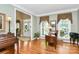 Well-lit living room with hardwood floors, large windows, and traditional decor at 13824 Glen Abbey Dr, Charlotte, NC 28278