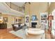 Elegant living room boasts a fireplace, built-in bookshelves, hardwood floors, and a soaring two-story ceiling at 13824 Glen Abbey Dr, Charlotte, NC 28278