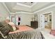 This spacious bedroom features tray ceilings, access to walk-in closets, and access to the ensuite bathroom at 13824 Glen Abbey Dr, Charlotte, NC 28278