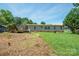 Exterior view of the backyard and back of the house with trees at 1495 Leonards Fork Church Rd, Lincolnton, NC 28092