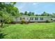 Traditional home featuring mature trees, an inviting porch, and a well-maintained lawn at 1495 Leonards Fork Church Rd, Lincolnton, NC 28092