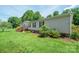Traditional home featuring lush trees and inviting front porch with stairs at 1495 Leonards Fork Church Rd, Lincolnton, NC 28092