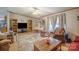 Inviting living room with ample natural light, comfortable seating, and a unique hanging chair at 1495 Leonards Fork Church Rd, Lincolnton, NC 28092