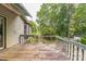 Well sized back deck featuring worn wooden planks and beautiful greenery in the backyard at 1713 Poe Cir, Hickory, NC 28601