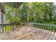 Wide wooden back deck surrounded by railings and lush greenery at 1713 Poe Cir, Hickory, NC 28601