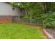 Picturesque backyard featuring lush green grass, mature trees, and a classic wooden fence at 1713 Poe Cir, Hickory, NC 28601
