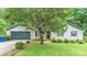 Charming single-story home featuring a blue garage door, lush lawn, and mature landscaping, creating a welcoming curb appeal at 1713 Poe Cir, Hickory, NC 28601