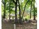 Secluded backyard featuring mature trees, charming birdhouses, and a tranquil garden setting at 1735 Robinwood Rd, Gastonia, NC 28054