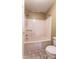 Bathroom with a shower-tub combo featuring a curtain rod and tile flooring at 1735 Robinwood Rd, Gastonia, NC 28054