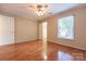 Bright bedroom with hardwood floors, window, ceiling fan and neutral color palette at 1735 Robinwood Rd, Gastonia, NC 28054