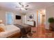 Primary bedroom featuring wood-look floors, ceiling fan, neutral walls, and back patio access at 1735 Robinwood Rd, Gastonia, NC 28054