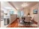 Elegant dining area with a glass table, upholstered chairs, and access to the kitchen at 1735 Robinwood Rd, Gastonia, NC 28054
