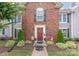 Inviting townhouse with a red door flanked by topiaries and well-maintained landscaping at 1735 Robinwood Rd, Gastonia, NC 28054