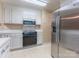 Functional kitchen featuring white cabinets, stainless steel refrigerator, built-in microwave, and smooth electric cooktop at 1735 Robinwood Rd, Gastonia, NC 28054