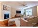 Cozy living room with a fireplace, modern furniture, and a large window at 1735 Robinwood Rd, Gastonia, NC 28054