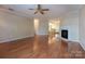 Open living space with hardwood floors and a fireplace, leading to a kitchen area at 1735 Robinwood Rd, Gastonia, NC 28054