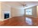 Bright, open living area with hardwood floors and a classic fireplace at 1735 Robinwood Rd, Gastonia, NC 28054