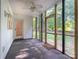 Relaxing sunroom features neutral carpet, a ceiling fan, and screened windows at 1735 Robinwood Rd, Gastonia, NC 28054