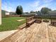 Backyard featuring a wood deck, bench seating, well-maintained lawn, and a fire pit at 1958 Leesburg Dr, Clover, SC 29710