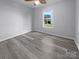Cozy bedroom with a large window offering ample natural light and hardwood flooring at 1958 Leesburg Dr, Clover, SC 29710