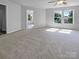 Spacious bedroom with plush carpet, multiple windows, and a ceiling fan at 1958 Leesburg Dr, Clover, SC 29710