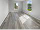 Bedroom with light colored, wood-look floors and large windows at 1958 Leesburg Dr, Clover, SC 29710