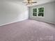 Light bedroom with plush carpet, a ceiling fan, and two large windows at 1958 Leesburg Dr, Clover, SC 29710