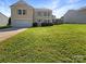 Charming two-story home with well-maintained lawn and attached garage, perfect for a Gathering at 1958 Leesburg Dr, Clover, SC 29710