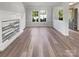 Spacious living room with wood-like flooring, large windows, and an elegant fireplace, ideal for entertaining at 1958 Leesburg Dr, Clover, SC 29710