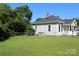 Large, grassy backyard with a chain-link fence, perfect for outdoor activities and relaxation at 201 Park Ave, Mount Holly, NC 28120