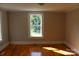 Neutral bedroom with hardwood floors features bright window for ample natural light at 201 Park Ave, Mount Holly, NC 28120